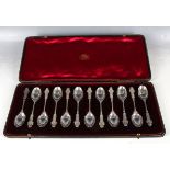 A fine cased set of twelve early Edwardian hallmarked silver spoons, embossed with scrolling