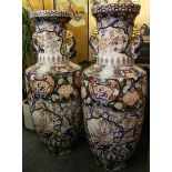 A pair of extremely large and impressive Imari style vases with cartouches, depicting landscapes,