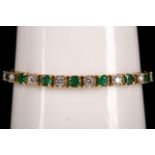 An 18ct yellow gold, emerald and diamond line bracelet.