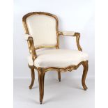 A 19th Century French giltwood and cream damask upholstered fauteuil.