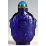 A Chinese blue Peking glass snuff bottle, dog of Fo to shoulders, dragons to main body and central