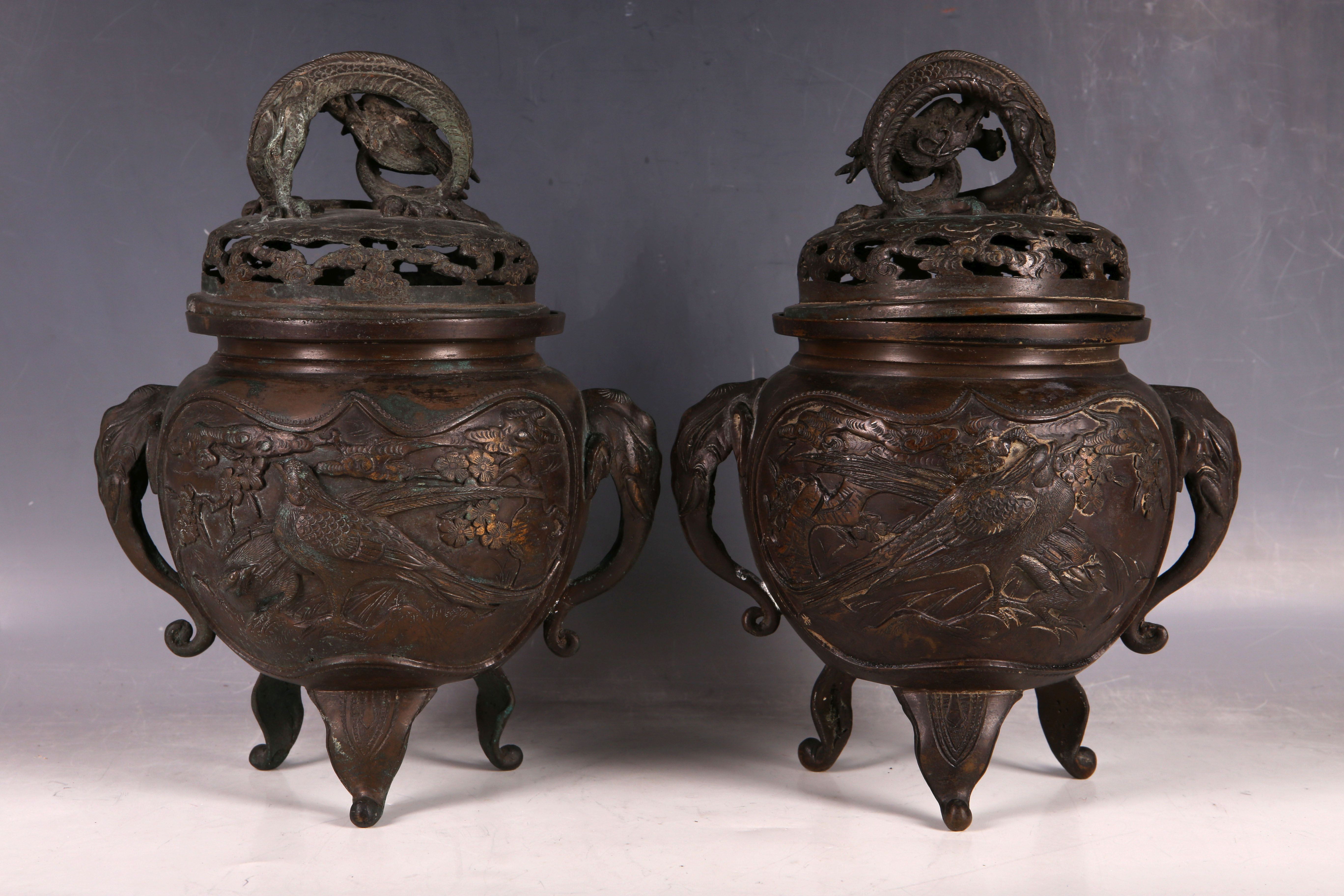 A pair of Japanese bronze incense burners, the body of each decorated with two panels with a pair of - Image 2 of 3