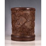 A Chinese carved bamboo brush pot, in relief study of a tree with gourd shape seed pods, 16.6cm H.