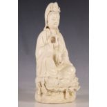A Chinese blanc de chine figure, study of Guylin goddess, holding an orchid and bottle vase,