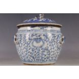 A Chinese lidded pot, dog of Fo finial, all over trailing leaf decoration, ceramic lugs for rope,