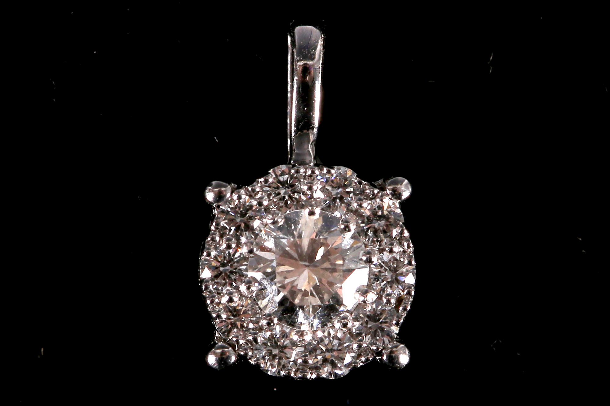 An 18ct white gold and diamond multi cluster pendant.