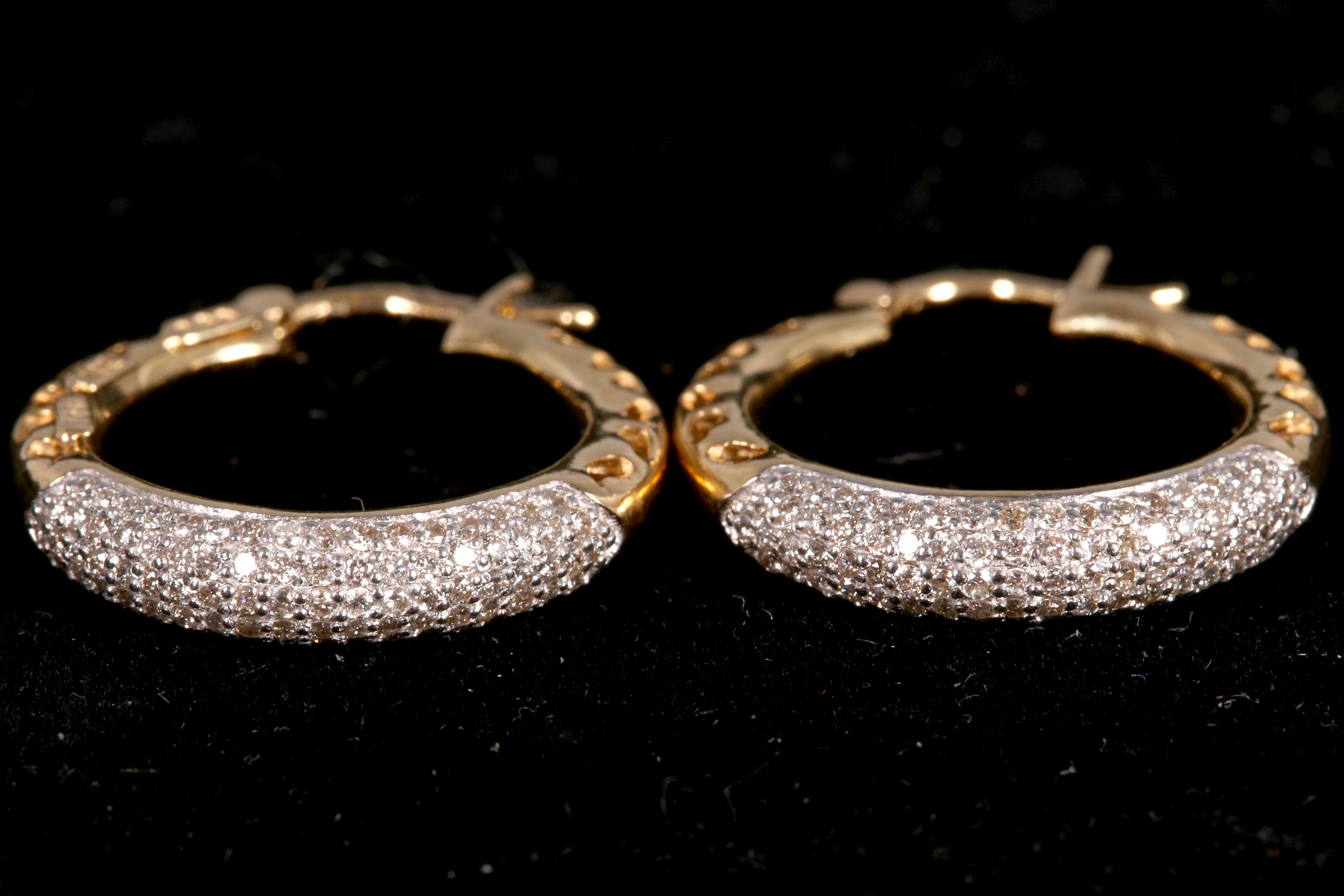 A pair of 18ct yellow gold and diamond hoop earrings, 0.99pts total.