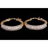 A pair of 18ct yellow gold and diamond hoop earrings, 0.99pts total.