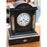 An Edwardian black slate clock with Roman numerals and chiming movement, 34 x 27cm.