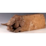 A late 19th/early 20th Century Indian wooden door stop, carved in the form of an elephant.