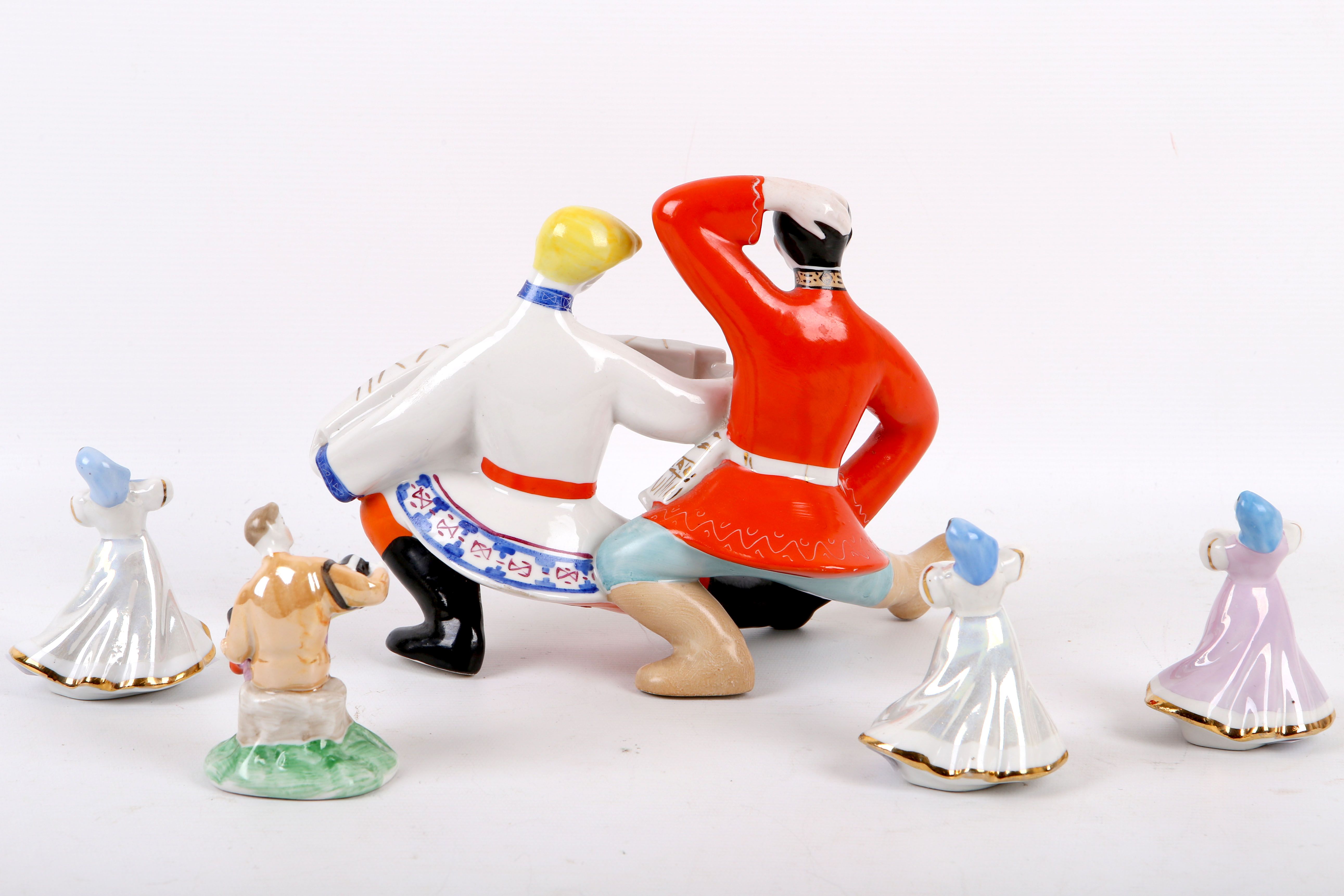 Group of five Soviet porcelain dancing figurines; three dancing girls, a boy playing garmoshka, - Image 2 of 8