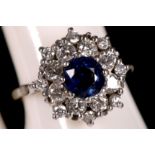 An 18ct white gold, sapphire and diamond cluster ring.