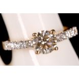 An 18ct yellow gold and diamond solitaire ring, the centre champagne round cut being 1.08ct and