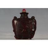 A Chinese snuff bottle, carved in the form of an elephant with howdah and banner of dragons, 7cm H.