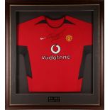 A Manchester United Football Club home strip, signed by Ryan Giggs, mounted and framed, with name