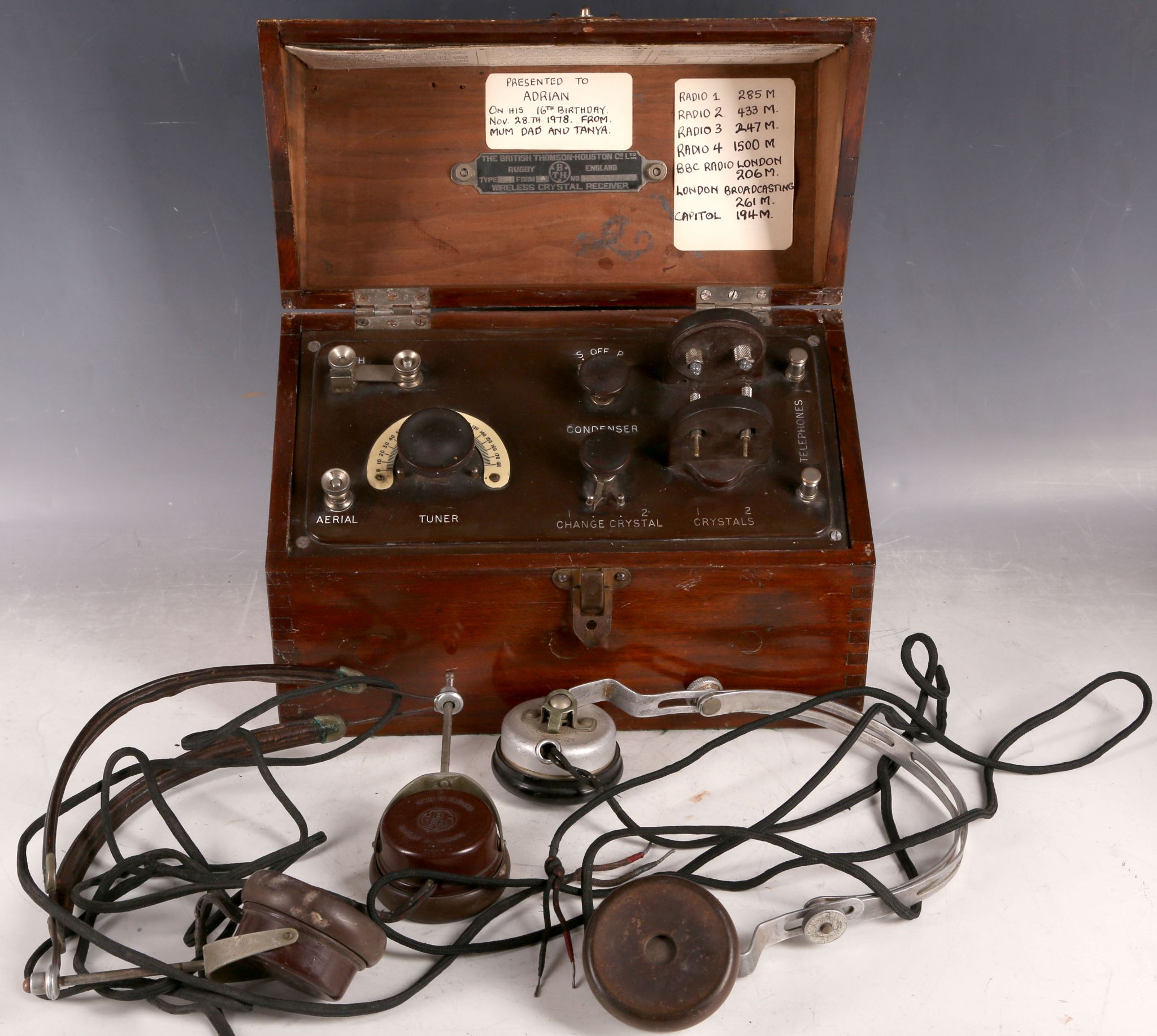 A mahogany cased British Thomson-Houston wireless crystal receiver and two pairs of earphones. (3)