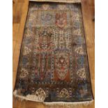 An Indian part silk rug, on blue ground, with six central panels, 156 x 92cm.