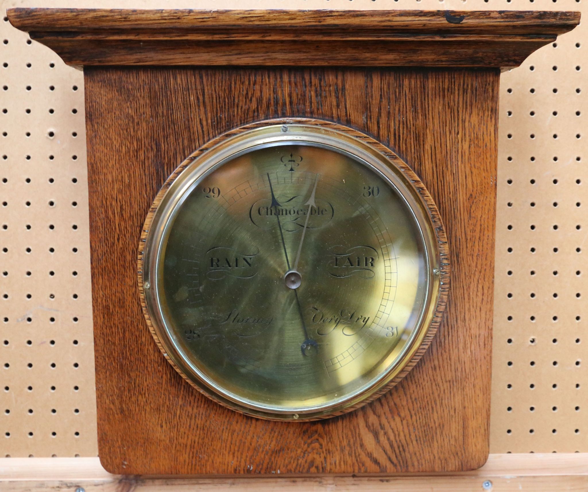 An Aitchison oak wall mounted barometer, with engraved brass dial (dial 21cm dia).
