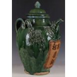 A large Chinese green glazed wine jug and cover, with peony modelled decoration, a mythical beast