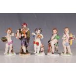 Five 19th Century Crown Naples porcelain figures, to include putti, two carrying flowers, and a