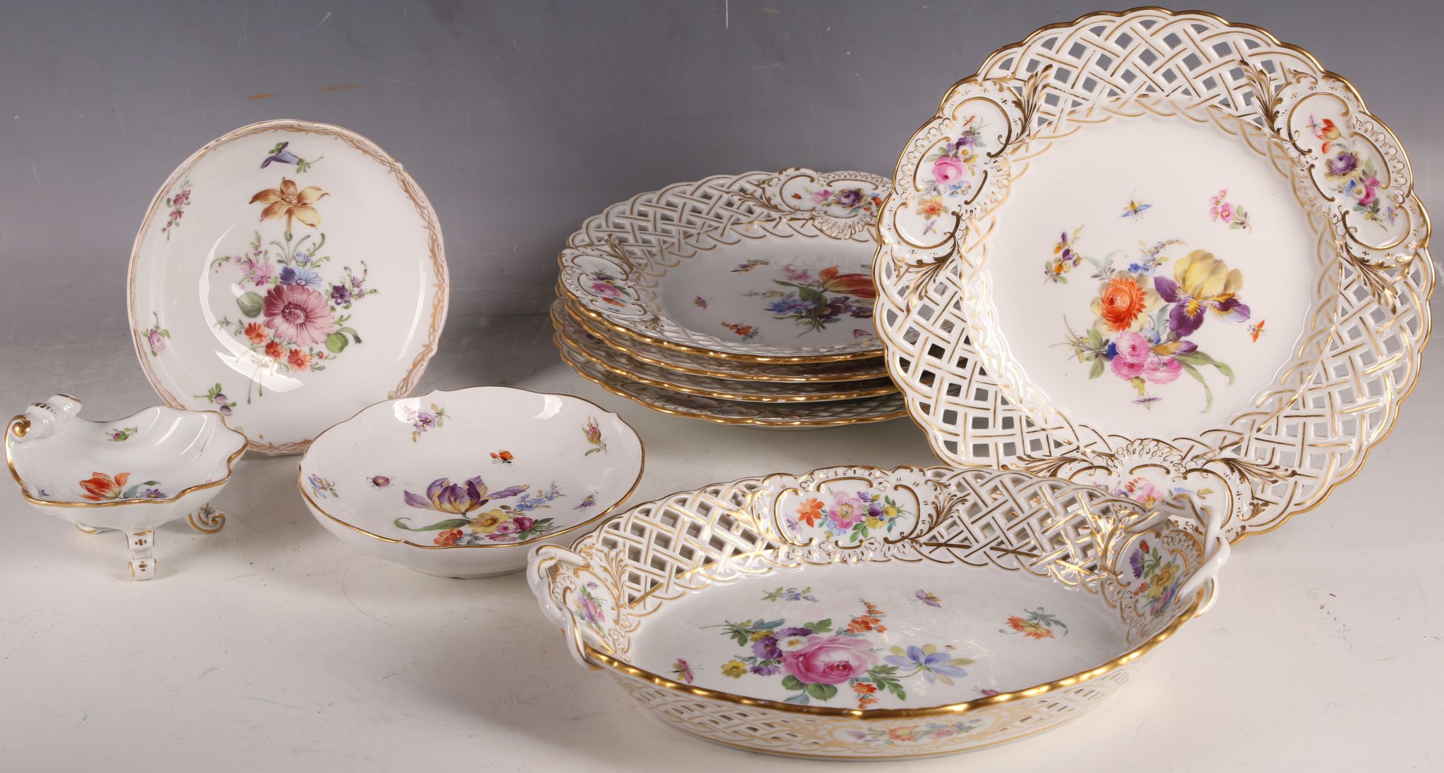 Five late 19th Century Meissen hard porcelain cabinet plates, painted centrally with Deutsche