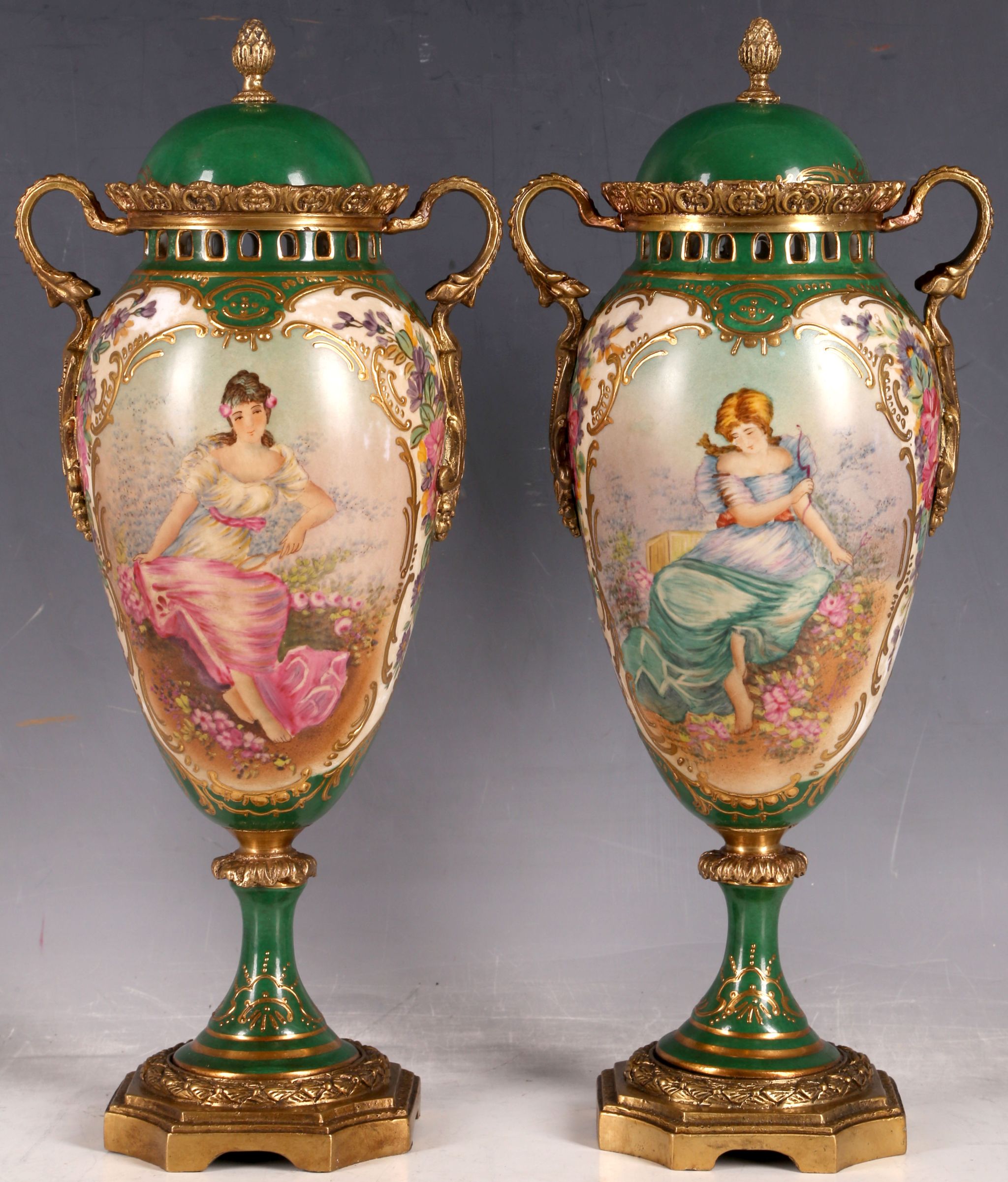 A pair of green glaze Empire style lidded jars, central panel with beauty, gilt and floral