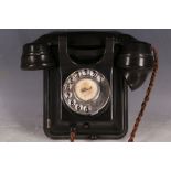 An old bakelite wall mounted telephone.