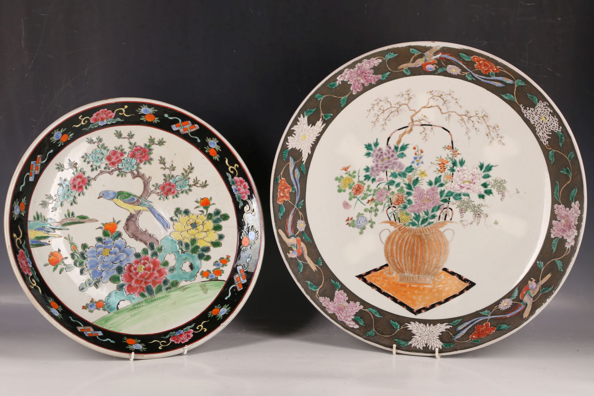 Two large famille noire dishes, one with a bird among flowers, the other with a flower bouquet, 40 /