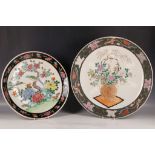 Two large famille noire dishes, one with a bird among flowers, the other with a flower bouquet, 40 /