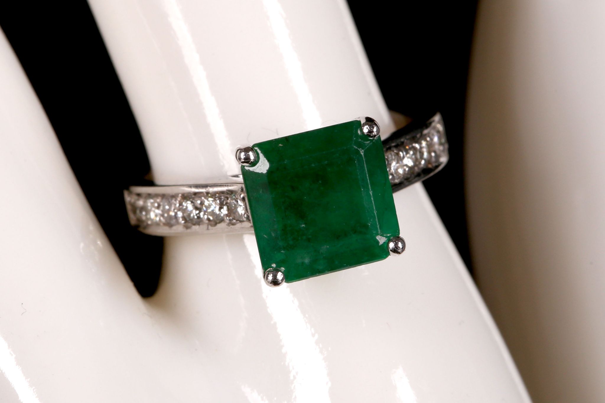 An 18ct white gold, emerald and diamond set ring (em. 3.40ct, dia. 0.47ct).