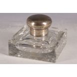 A cut glass and silver plated desk inkwell.