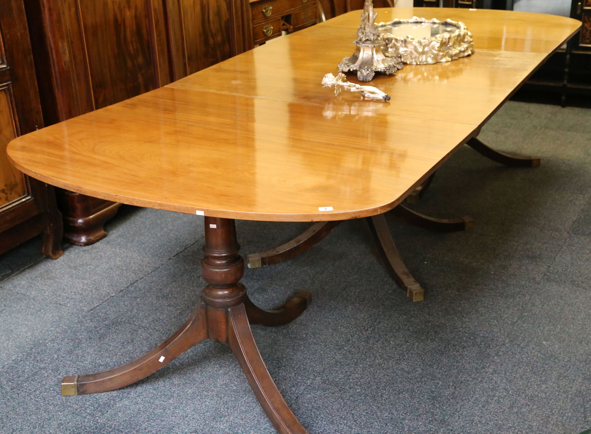 A mid 20th Century mahogany dining table, in Regency style, with three pedestals and central leaf,