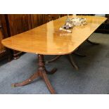 A mid 20th Century mahogany dining table, in Regency style, with three pedestals and central leaf,