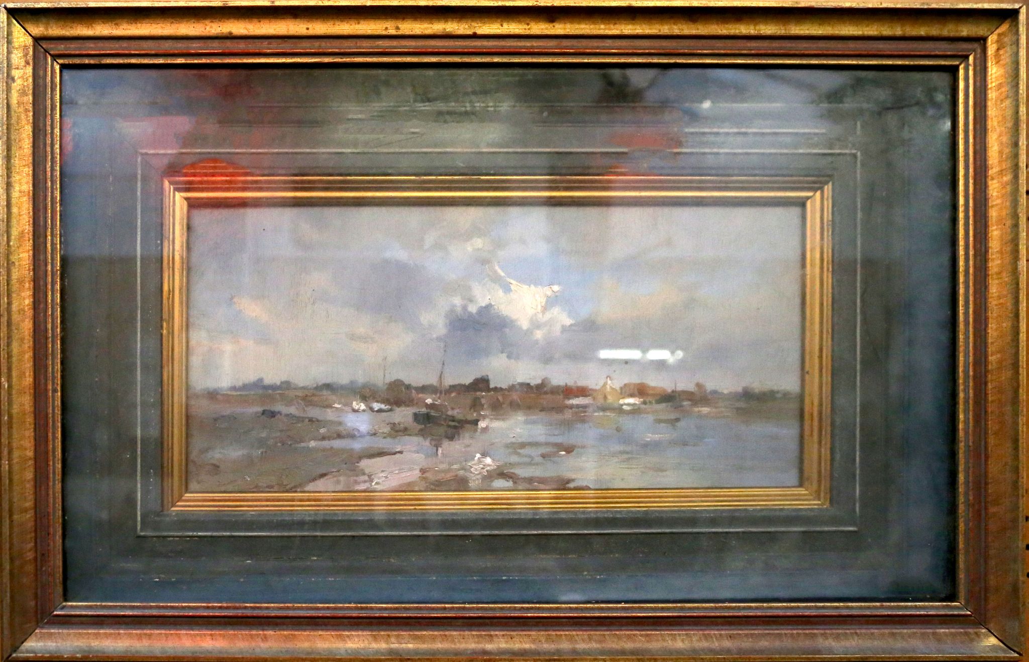 An oil on board, an extensive view of a tranquil English coastal scene, with fishing boats in low