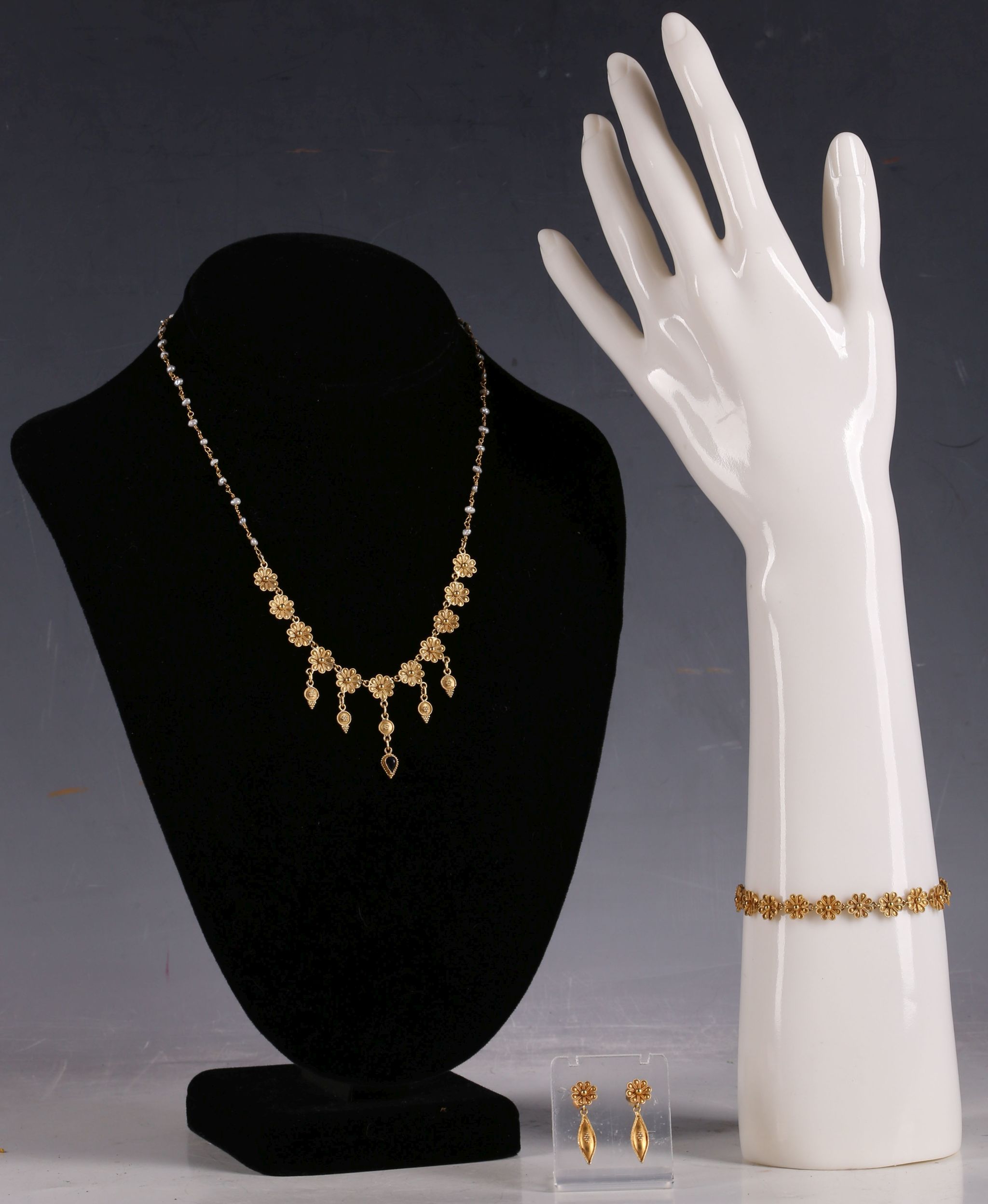 A 22ct gold and seed pearl necklace, with floral roundel links and sapphire drop, together with