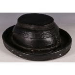 A rare 19th Century Billingsgate porters bobbin hat, covered in pitch, 30cm W.