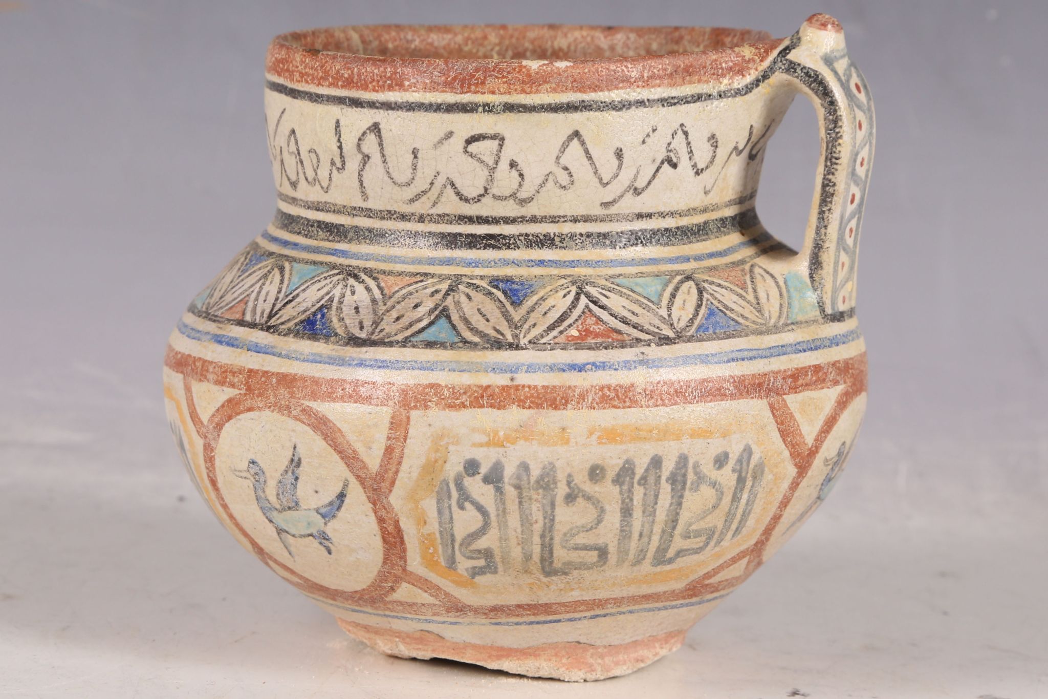 An Iranian single-handled vase, decorated with rings of calligraphic inscriptions and floral - Image 2 of 3