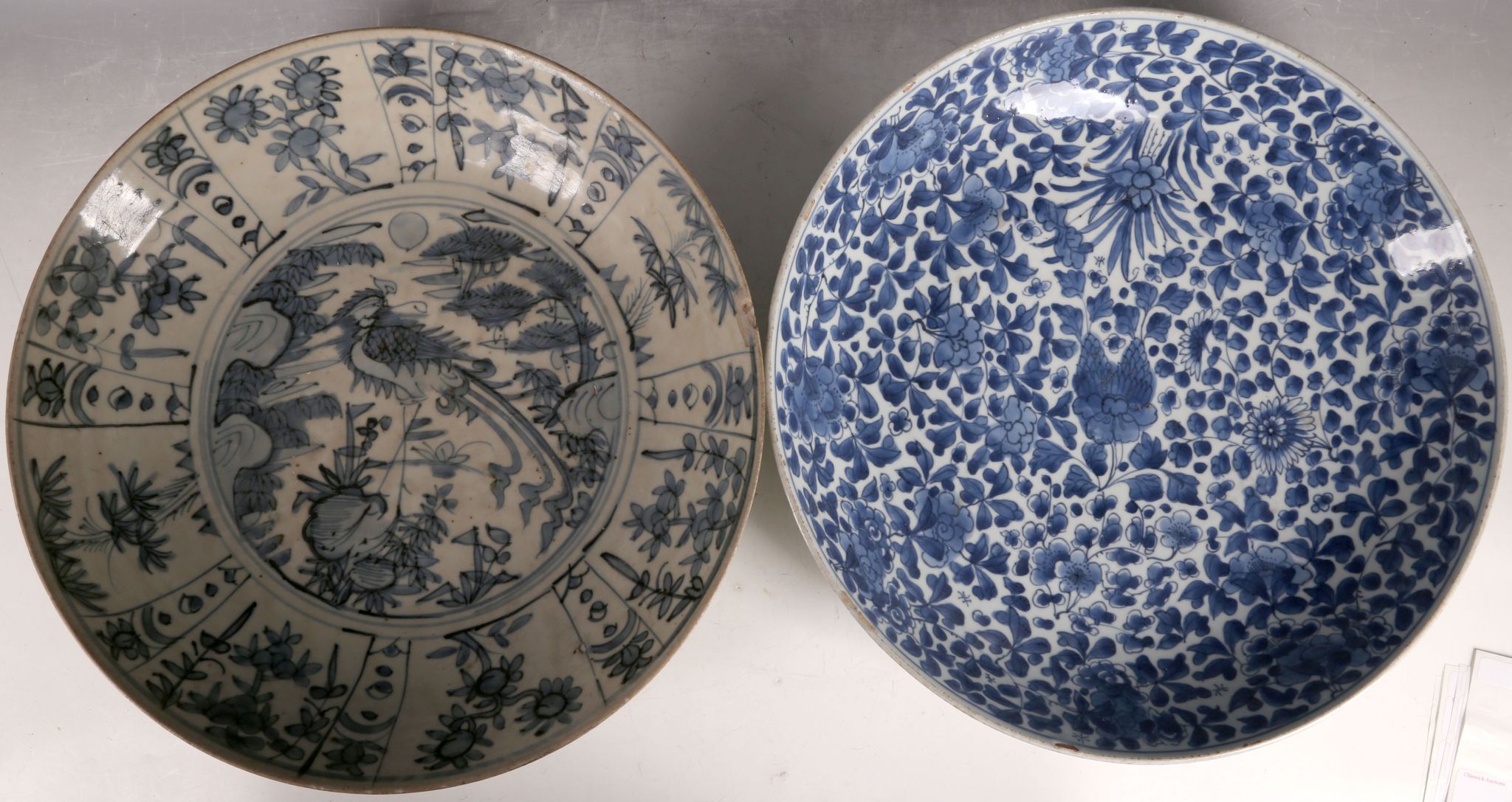 A Chinese large blue and white dish, decorated with a phoenix, together with another blue and