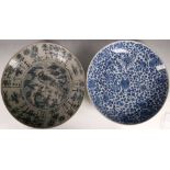 A Chinese large blue and white dish, decorated with a phoenix, together with another blue and