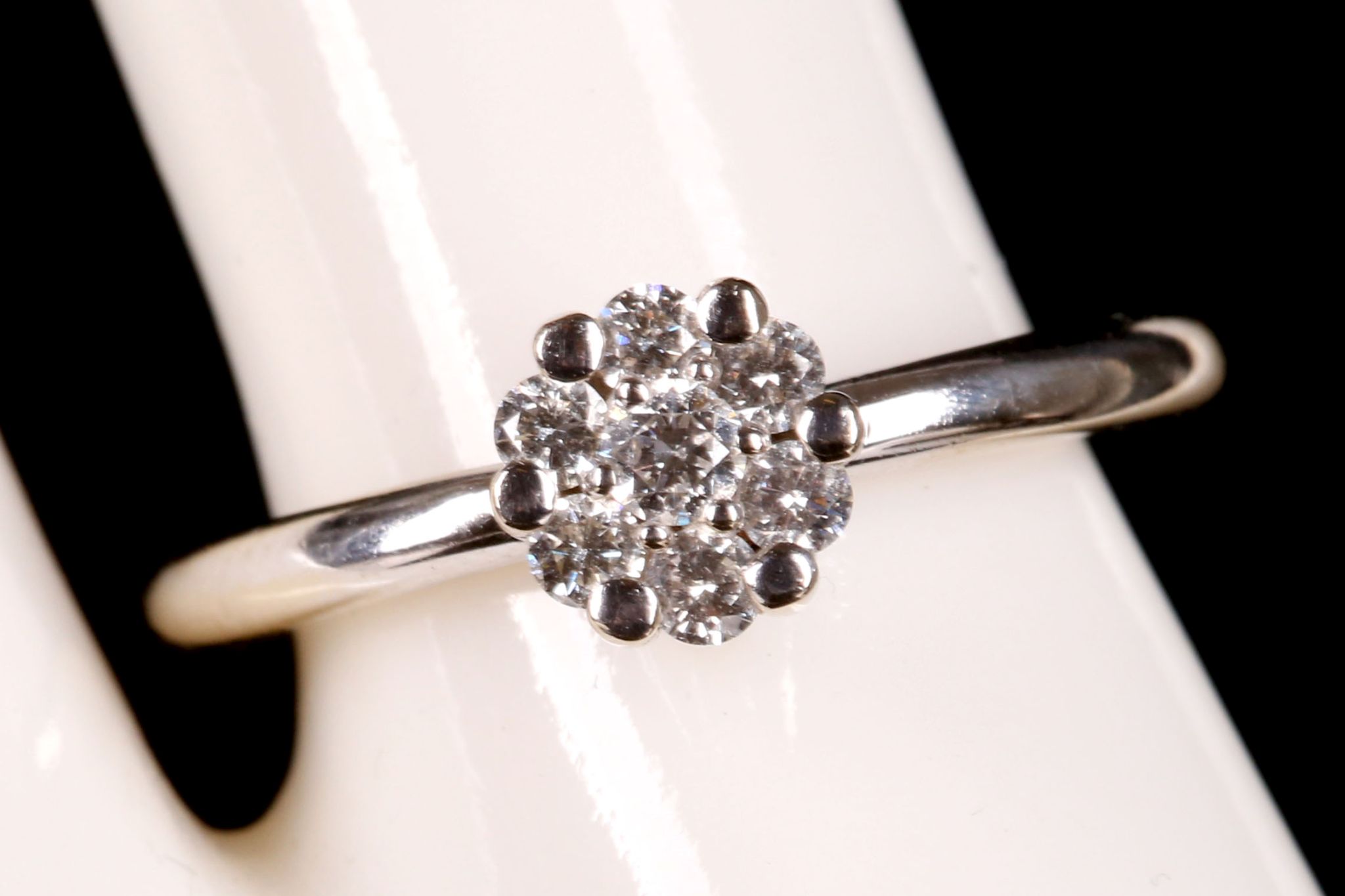 An 18ct white gold and diamond cluster illusion set ring.