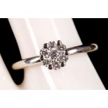 An 18ct white gold and diamond cluster illusion set ring.