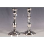 A pair of very early 20th Century sterling silver desktop candlesticks, with circular bases and