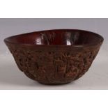 A Chinese ox horn bowl, carving to flank of the eight immortals in garden / forest scene, 12.5cm