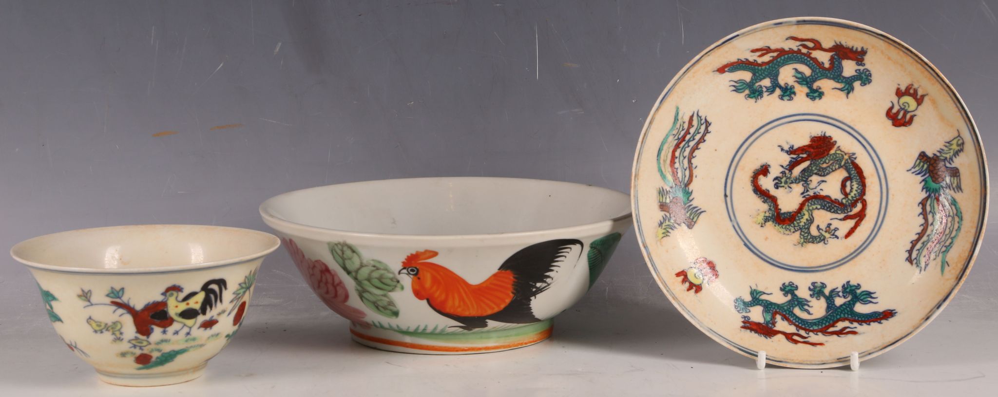 A Chinese rice bowl, chicken decoration and matching saucer with dragon, six character marks and