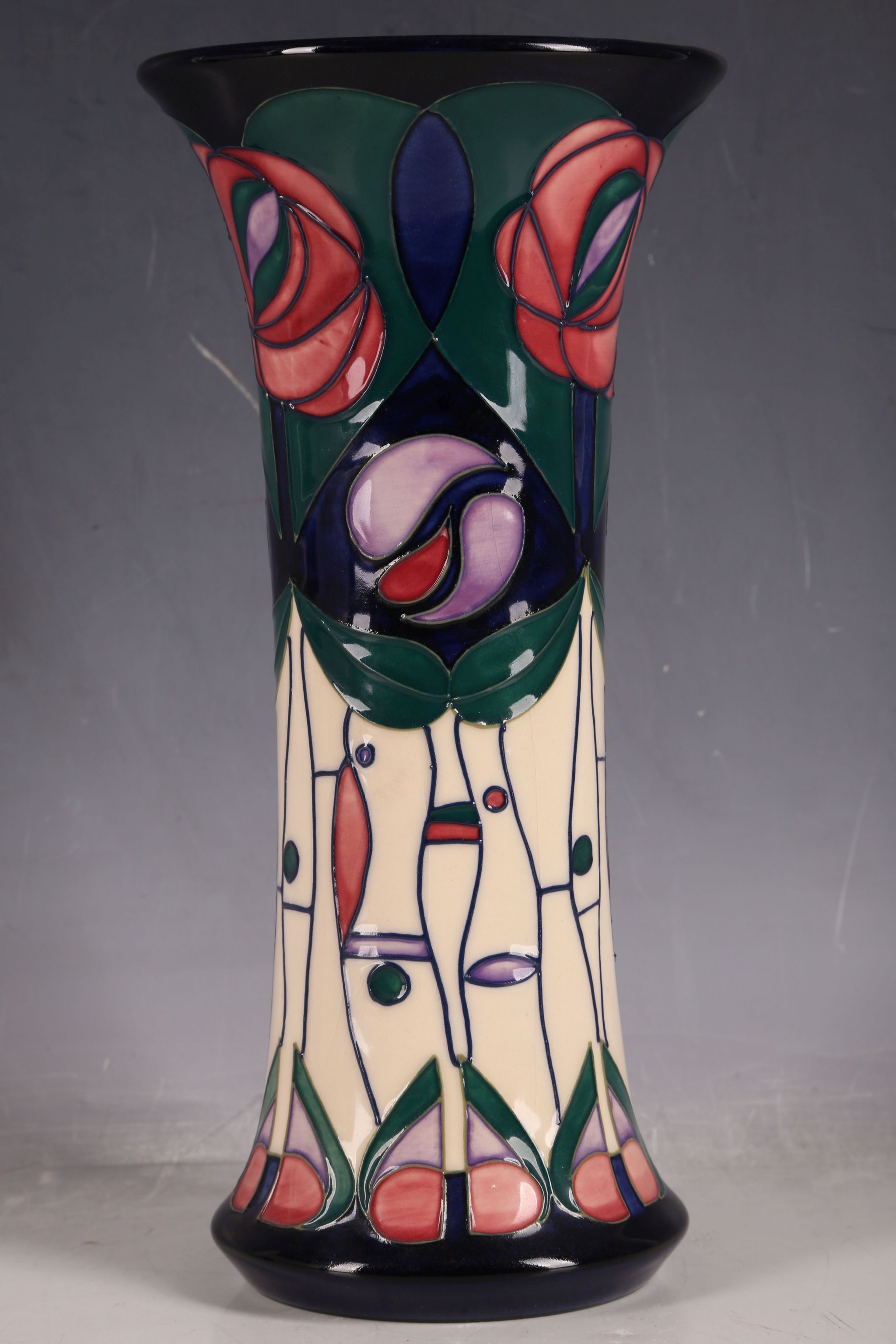 A Moorcroft tube-line vase, everted rim, Mackintosh rose pattern, marks for Ann Bishop, 25.9cm H.
