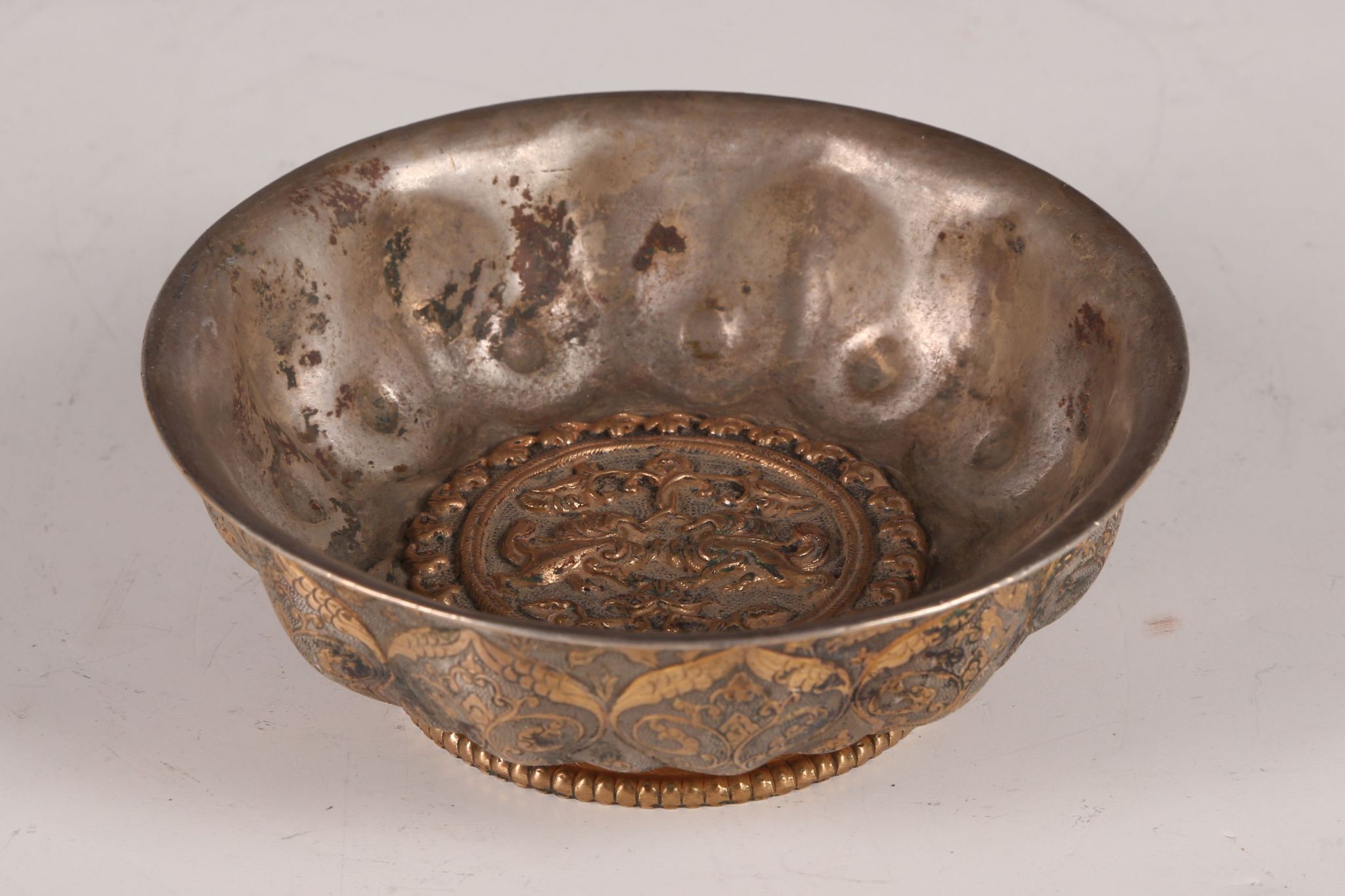 A Chinese lobed dish, with inlaid decoration to the exterior and a circular panel of deeply