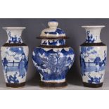 A garniture of Chinese blue and white decorated vases and jar. (3)