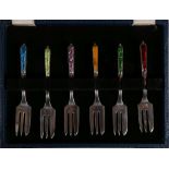 A cased set of six silver dessert forks, with multi-coloured enamel handle decoration.