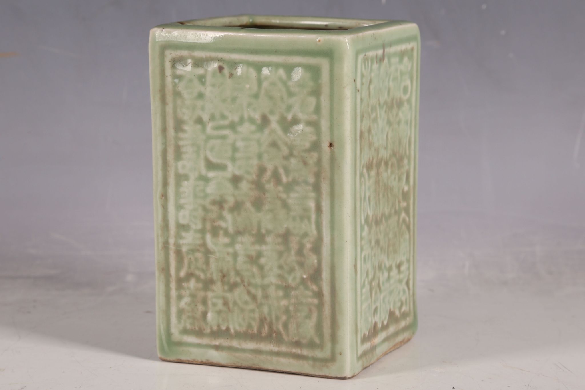 A Chinese celadon box form vase, inscriptions in relief to all panels, character marks to base, 12.