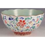 A Chinese serving bowl, fluted rim, sea green interior, floral enamelled decoration, Greek key to
